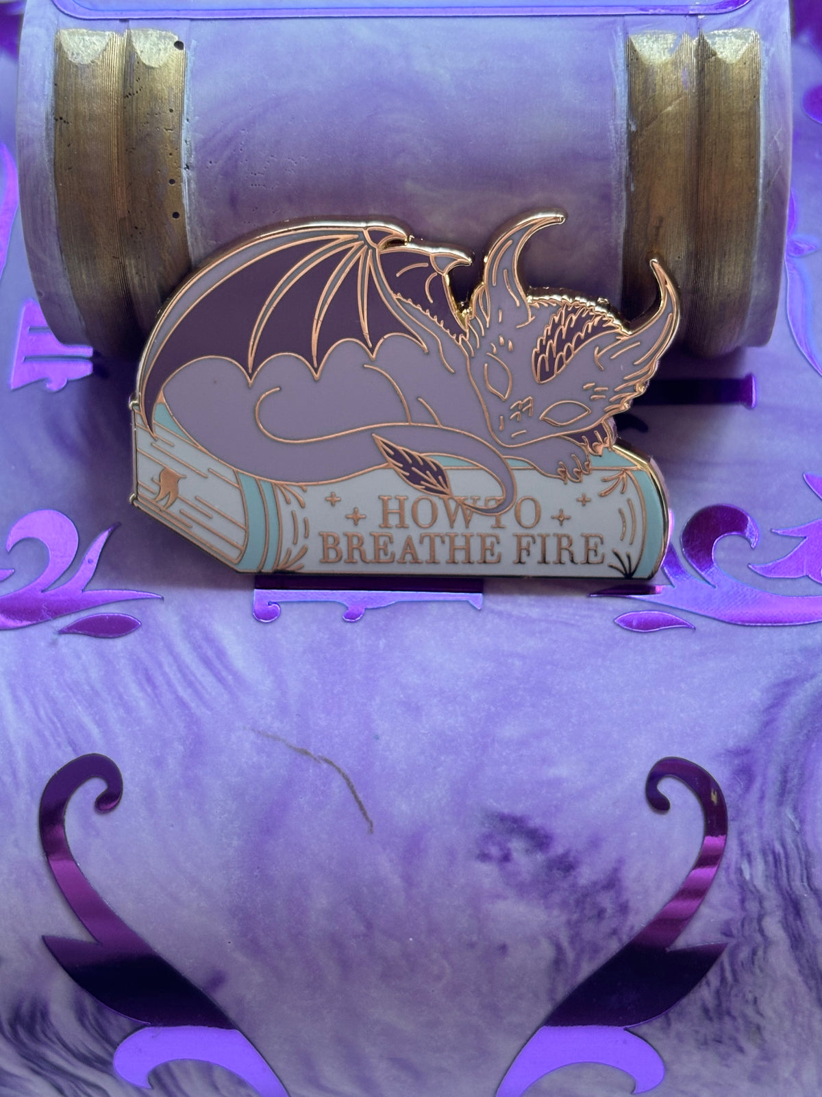 Baby Sleeping Dragon Bookstack Pin Badge. How to breathe fire.