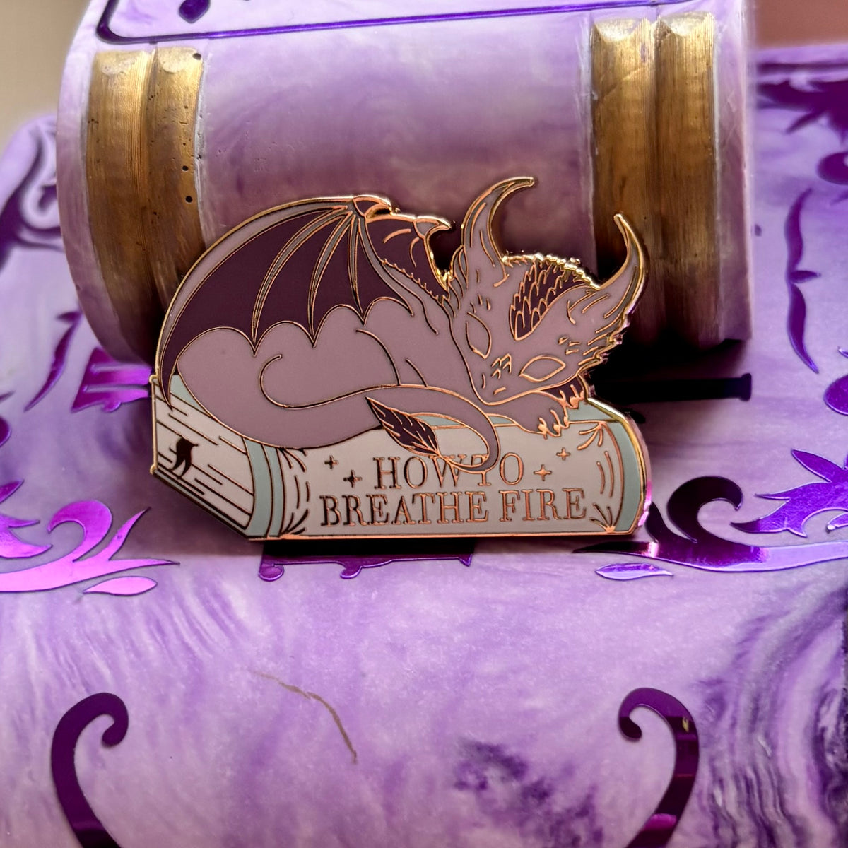 Baby Sleeping Dragon Bookstack Pin Badge. How to breathe fire.