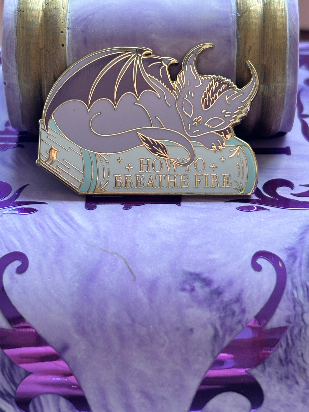 Baby Sleeping Dragon Bookstack Pin Badge. How to breathe fire.