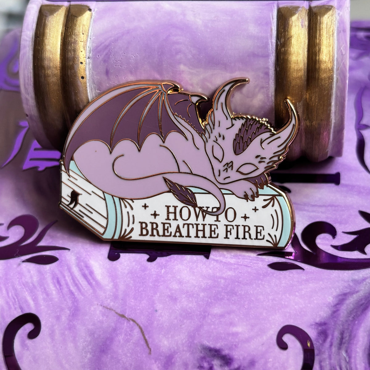 Baby Sleeping Dragon Bookstack Pin Badge. How to breathe fire.