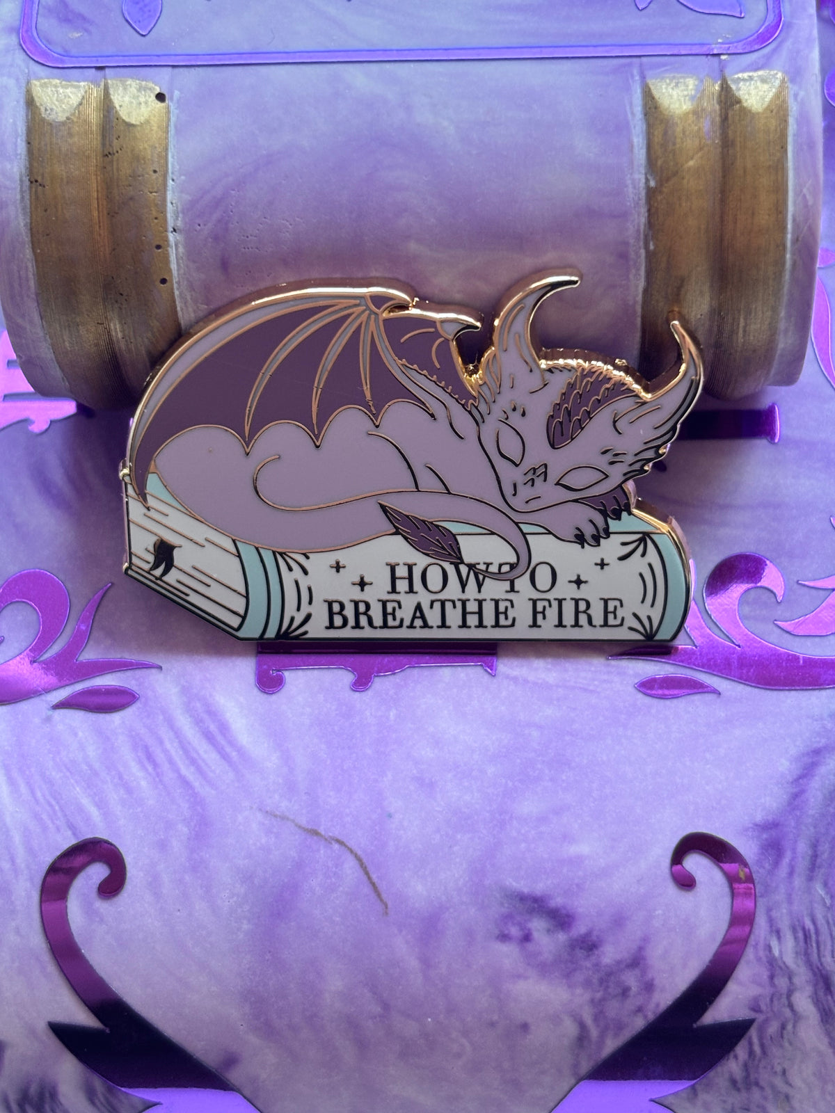 Baby Sleeping Dragon Bookstack Pin Badge. How to breathe fire.