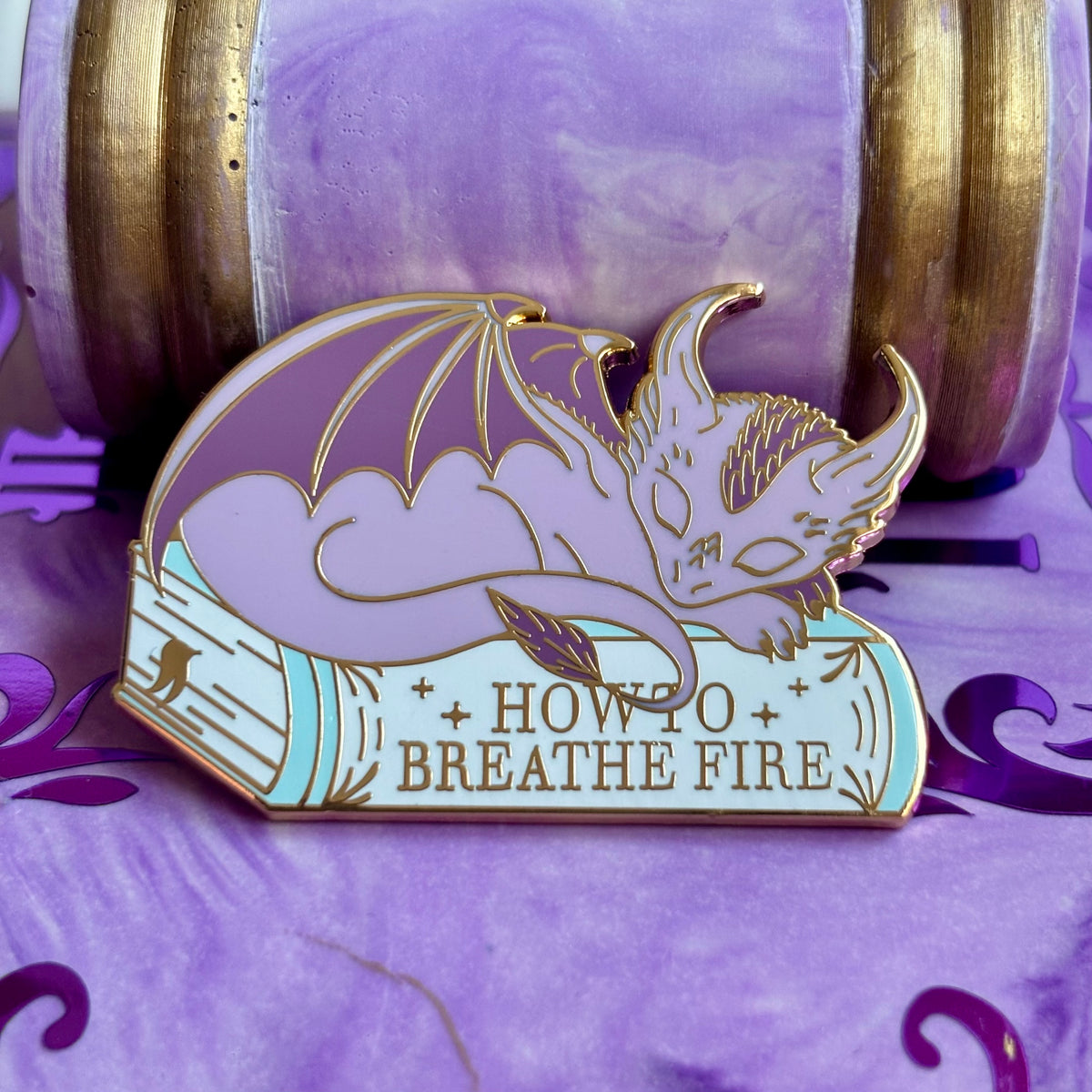 Baby Sleeping Dragon Bookstack Pin Badge. How to breathe fire.