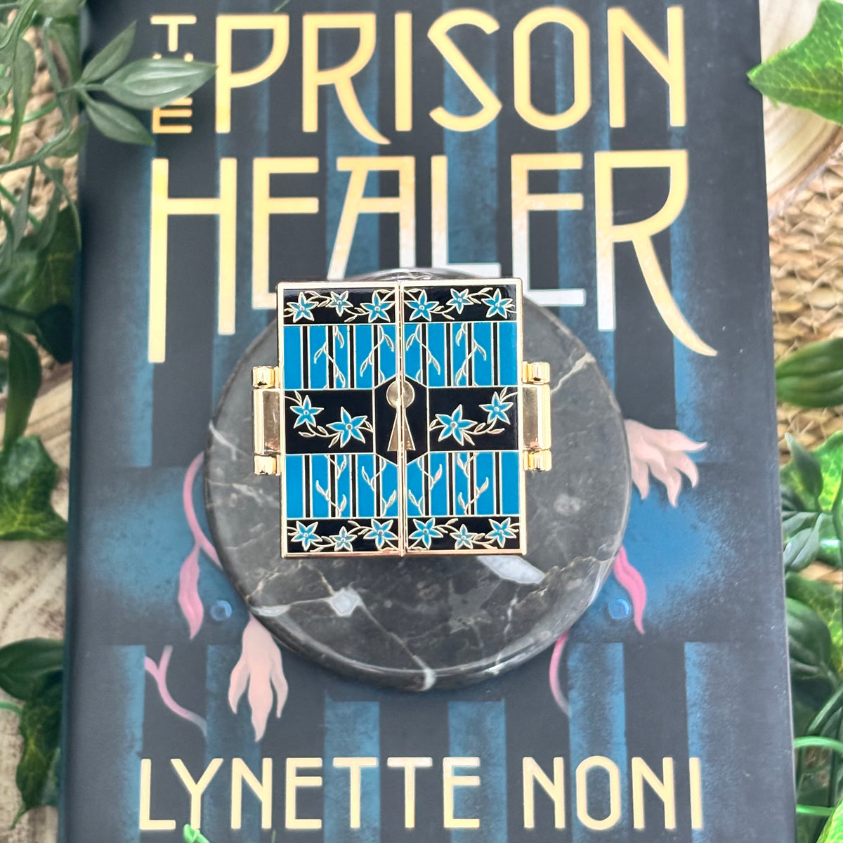 The Prison Healer Officially Licensed Pin Badge - Lynette Noni. Interactive pin badge in hard enamel.