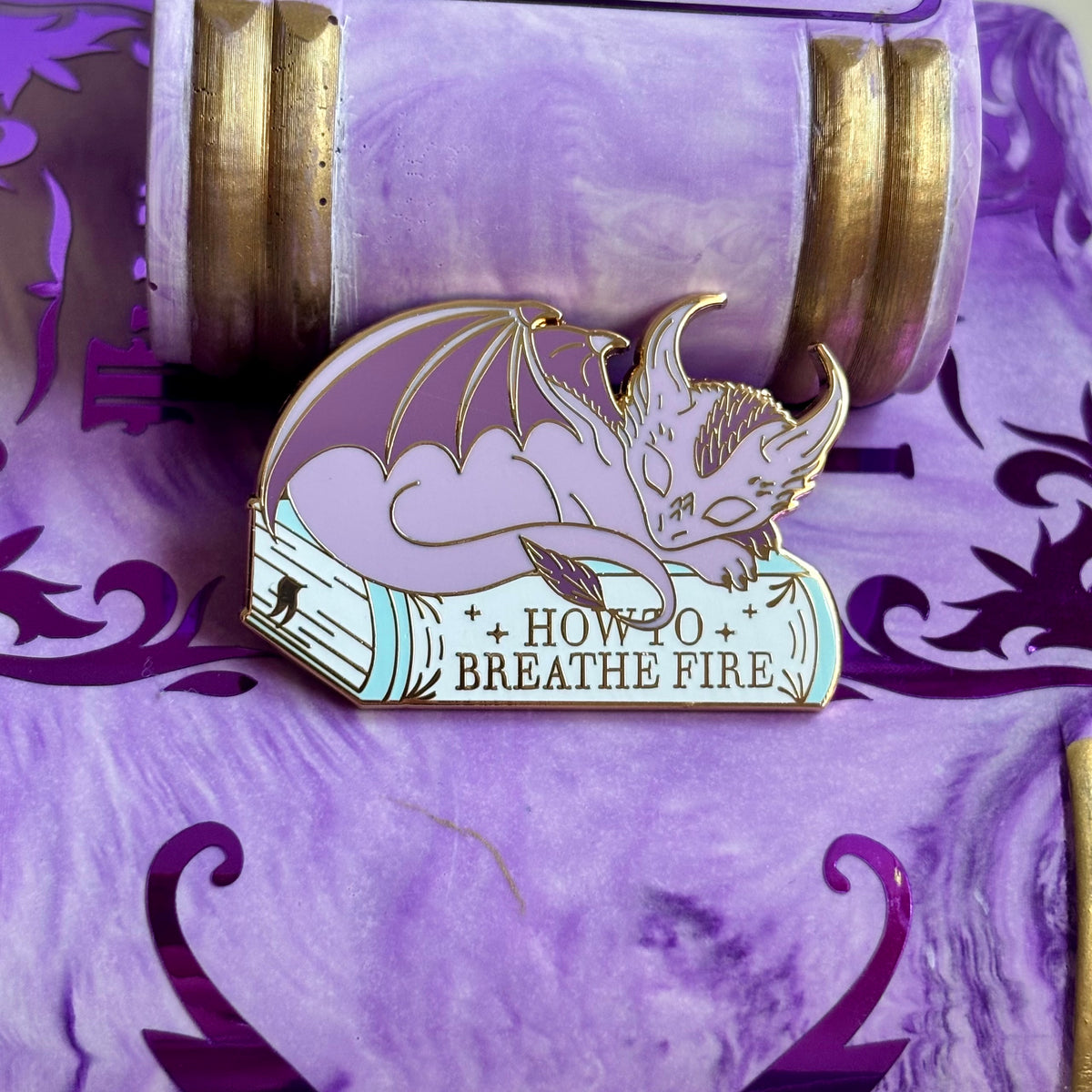 Baby Sleeping Dragon Bookstack Pin Badge. How to breathe fire.