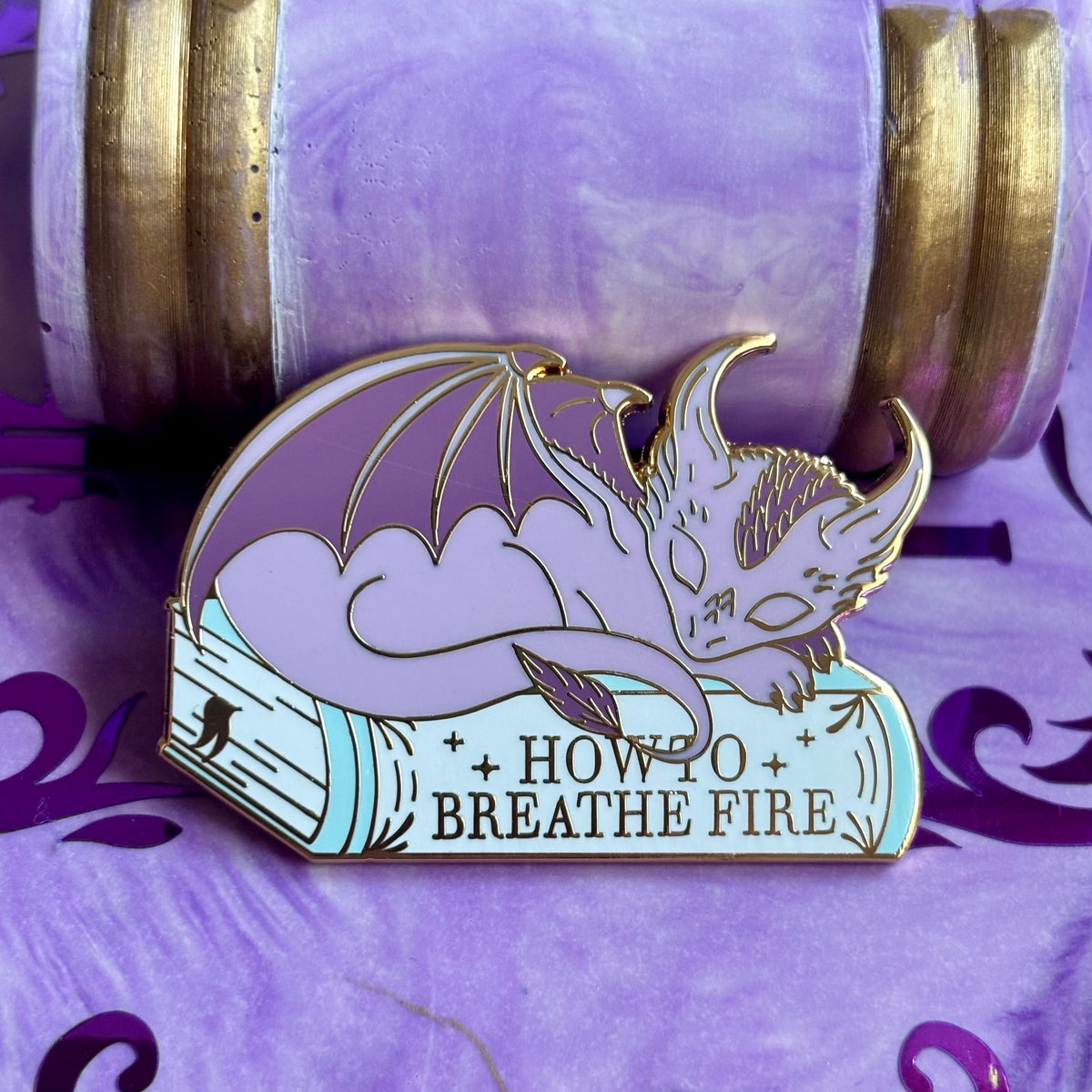 Baby Sleeping Dragon Bookstack Pin Badge. How to breathe fire.