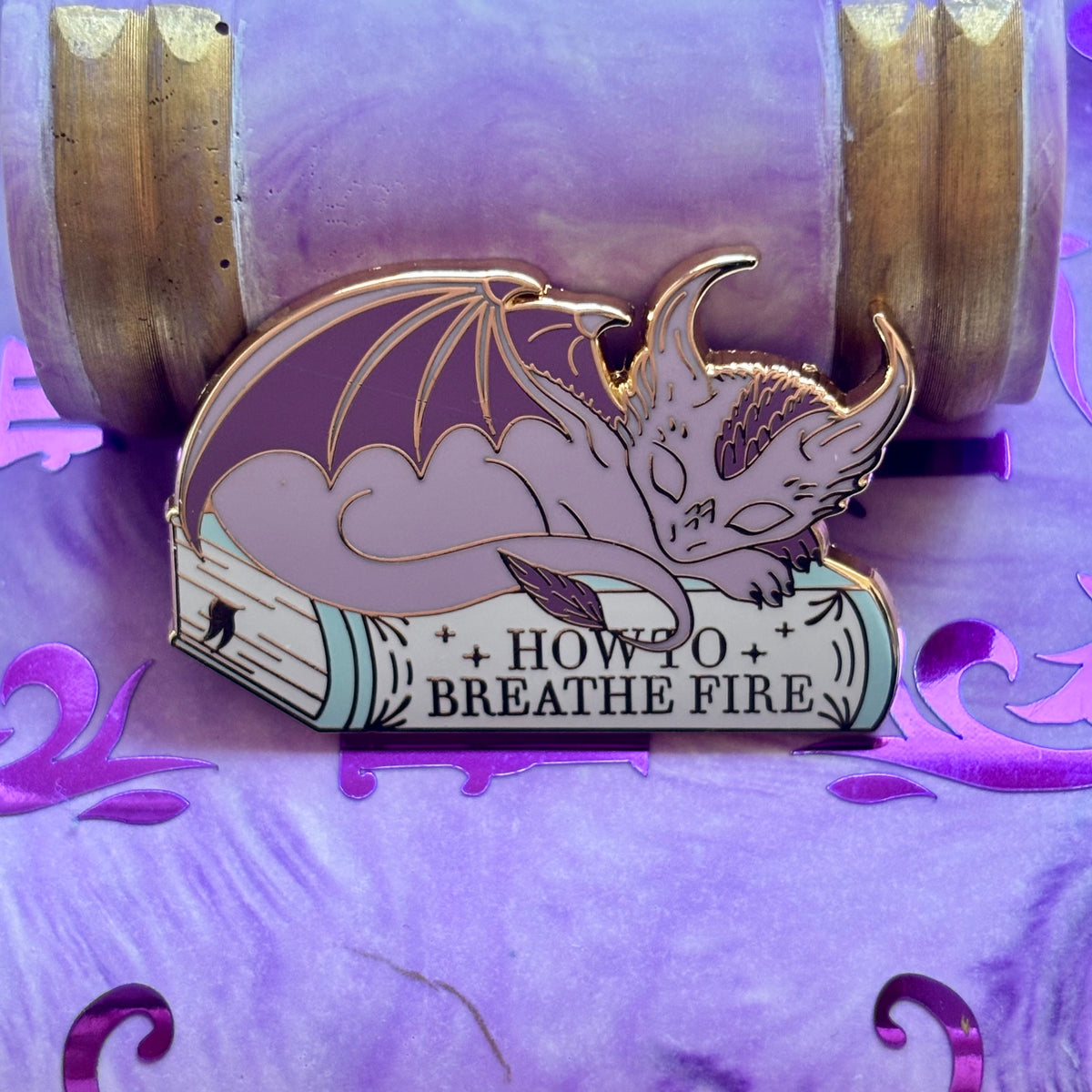 Baby Sleeping Dragon Bookstack Pin Badge. How to breathe fire.