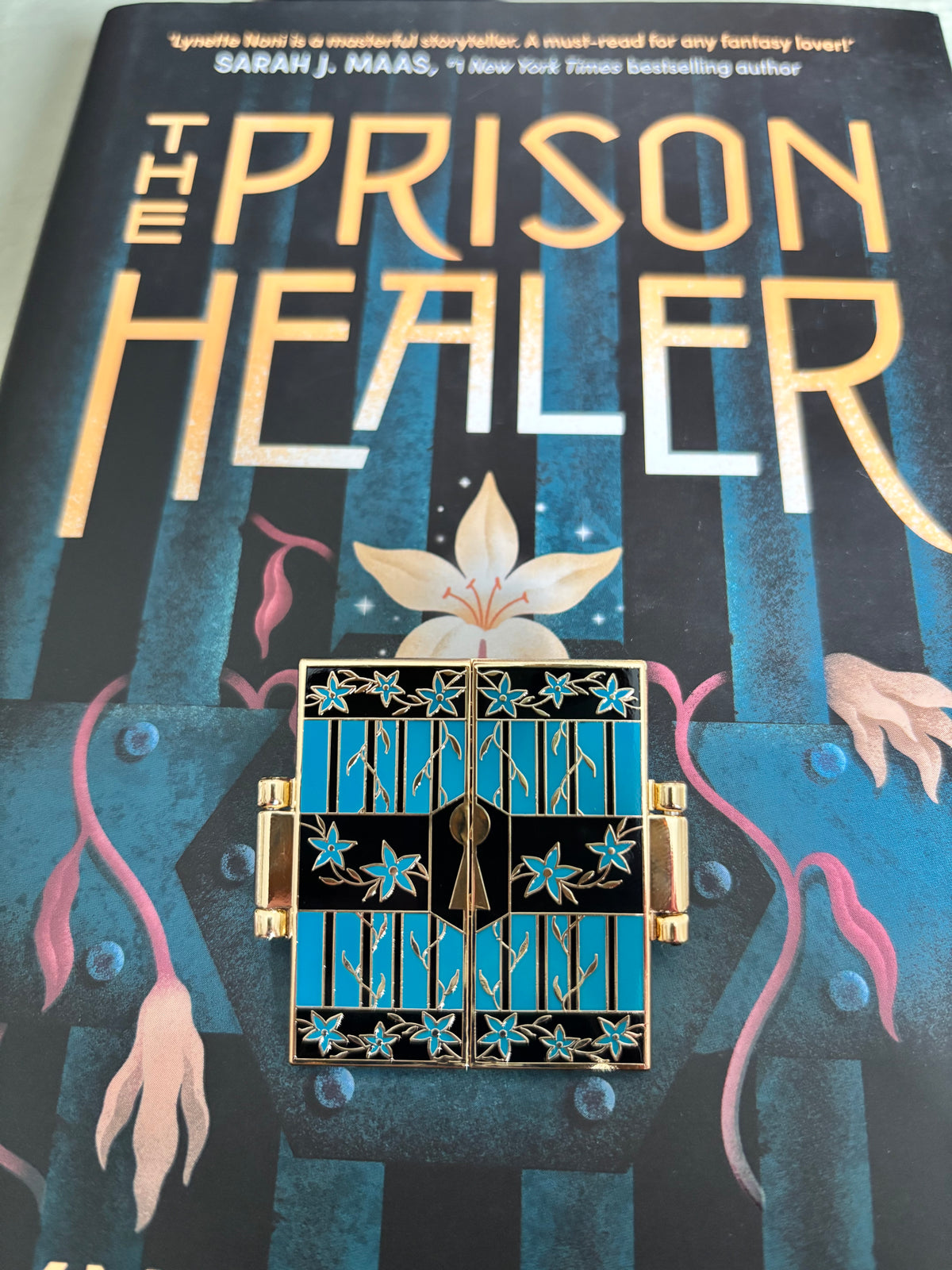 The Prison Healer Officially Licensed Pin Badge - Lynette Noni. Interactive pin badge in hard enamel.