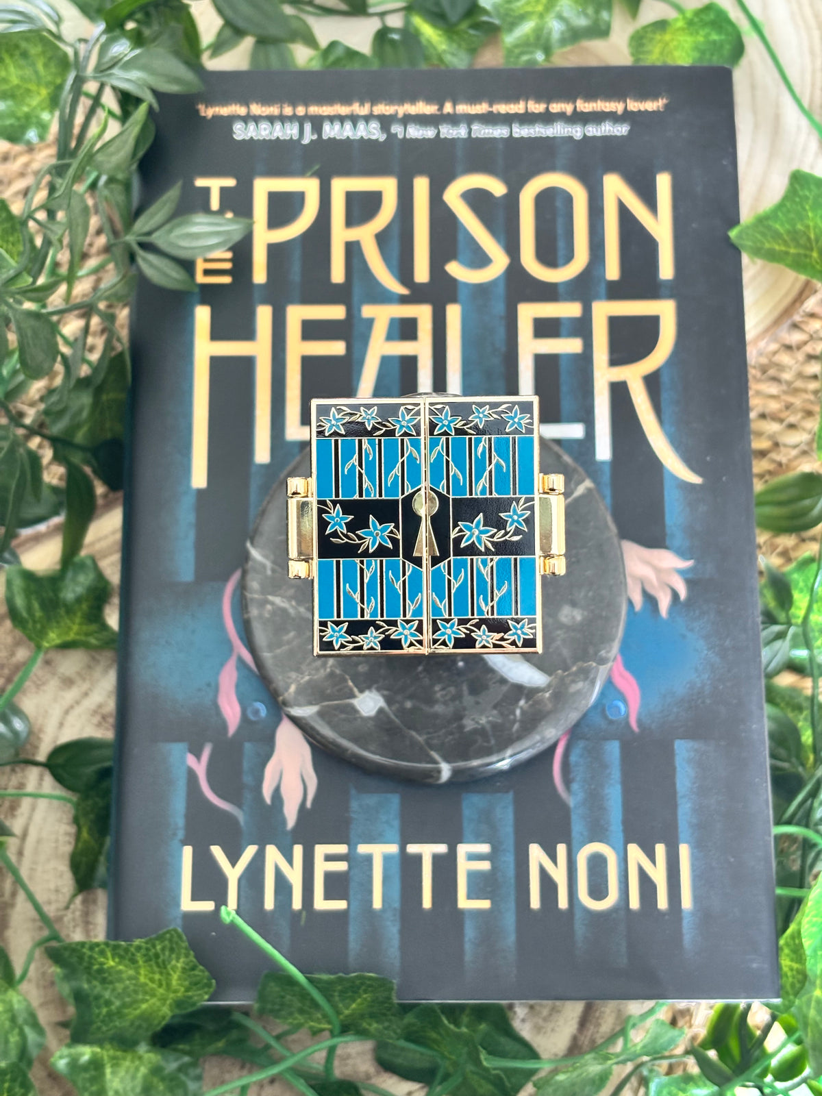 The Prison Healer Officially Licensed Pin Badge - Lynette Noni. Interactive pin badge in hard enamel.