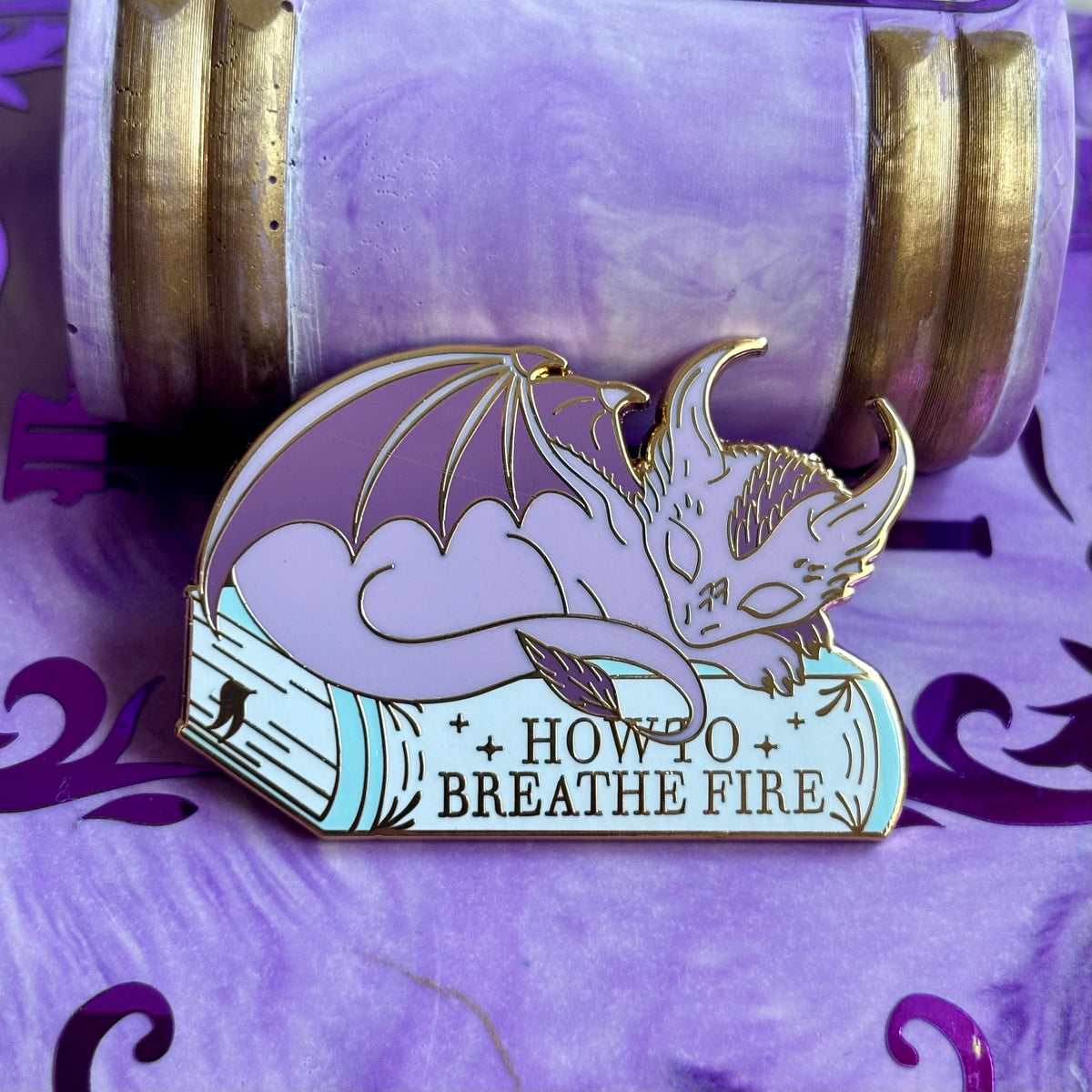 Baby Sleeping Dragon Bookstack Pin Badge. How to breathe fire.